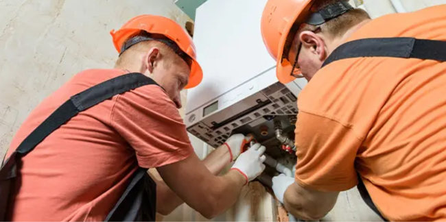 Men in orange servicing electrical box